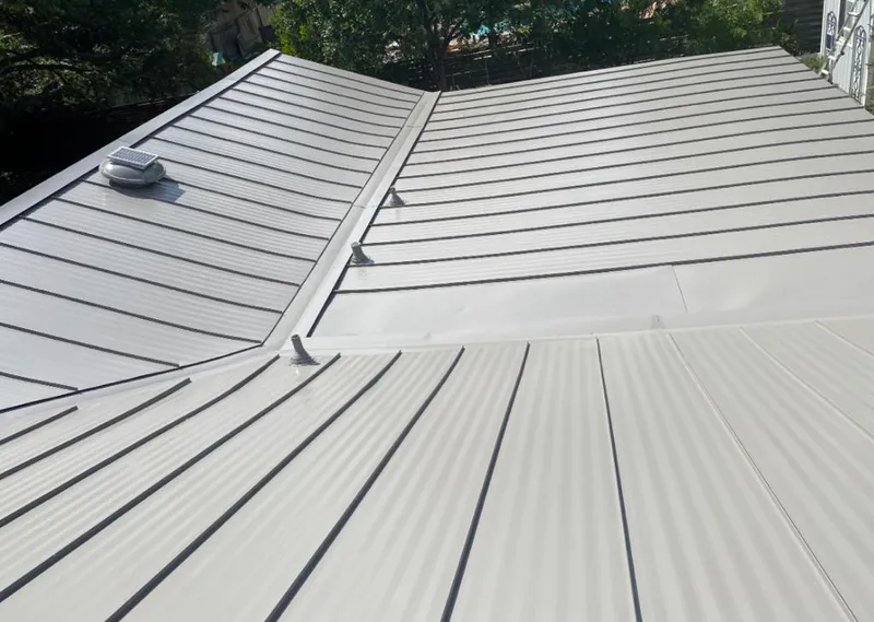 Solar attic fan installed on a metal roof for Roof Ventilation in Lake Grove